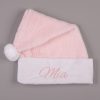 Pink Baby Christmas Hat Mia Pink faux fur personalised baby Santa hat with white cuff, pompom and pink embroidered script name on grey background.
