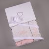Pink personalised baby Christmas stocking and hat set folded side by side in open One Little Day gift box with white ribbon bow.