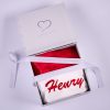 Red Christmas Baby Hat Gift Box Red Christmas Baby Hat folded inside of a white gift box with ribbon.
