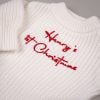 White 1st Christmas Baby Long Sleeve Romper Close up of white knitted baby romper chest with red embroidered personalised 1st Christmas script text.