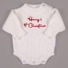 White 1st Christmas Long Sleeve Romper Henry White knitted long sleeve baby romper with red embroidered personalised 1st Christmas text and snap button closures on grey background.