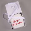 White 1st Christmas Newborn Romper Box White knitted personalised 1st Christmas newborn romper folded in open One Little Day gift box with white ribbon bow.