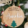 My First Christmas Tree Personalised Disc. Amelia Close-up of personalised wooden Christmas Disc engraved with My First Christmas and Amelia in white with green tree detail