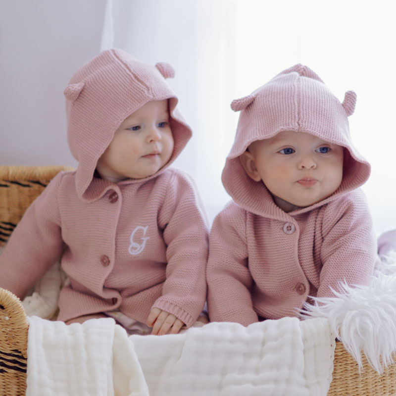 2 Baby Girls Sitting Next Another Wearing Our Personalised Cardigan
