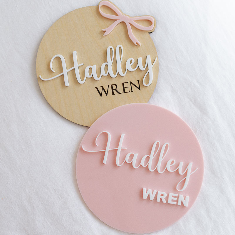 2 Birth Announcement Discs On A White Cloth