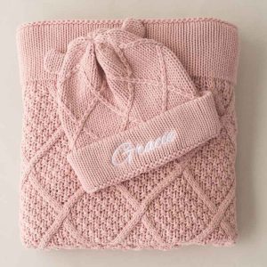 Blush pink knitted baby blanket and beanie with diamond pattern, personalised with the embroidered name Gracie.