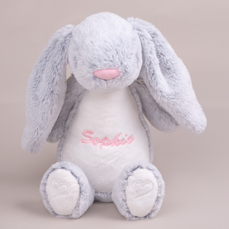 Cuddly personalised bunny resting in a soft, cosy setting.