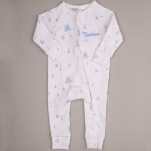 White baby onesie with blue sailboats, anchors, lighthouses, front zipper, and embroidered name ‘Thomas.’