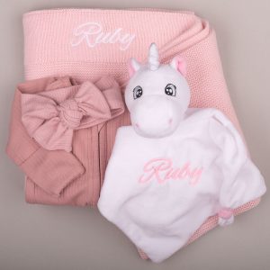 Personalised pink baby gift set featuring unicorn comforter, cosy blanket, headband & embroidered Ruby onesie.