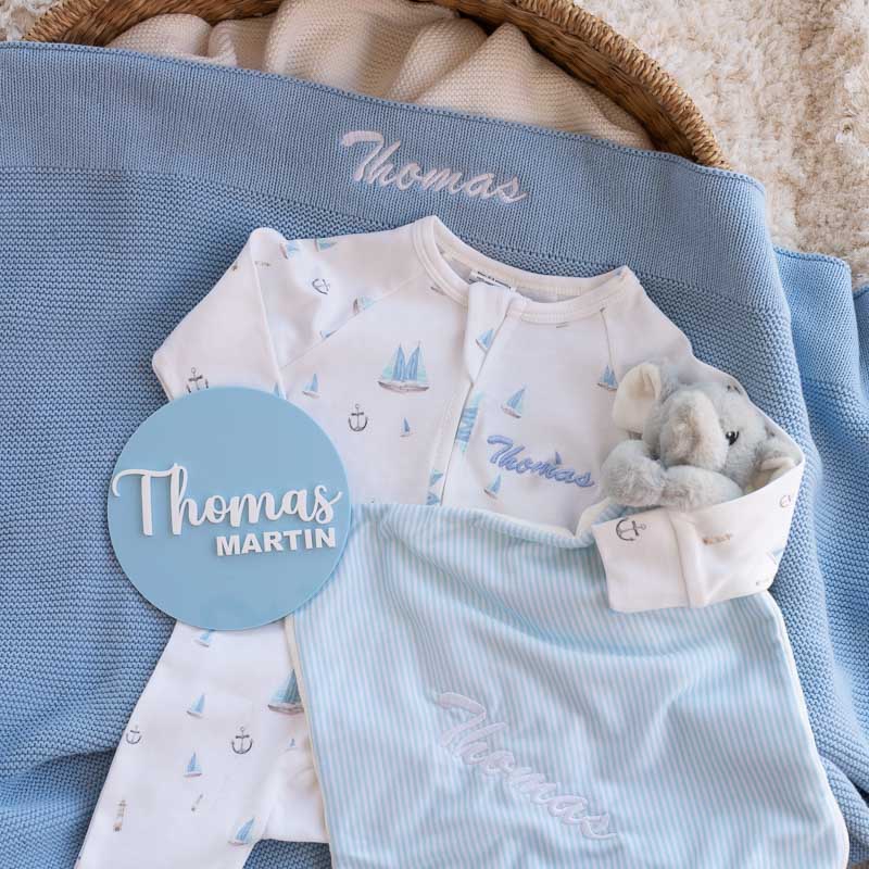 Blue personalised nautical baby gift set with blanket, onesie, comforter and name disc.
