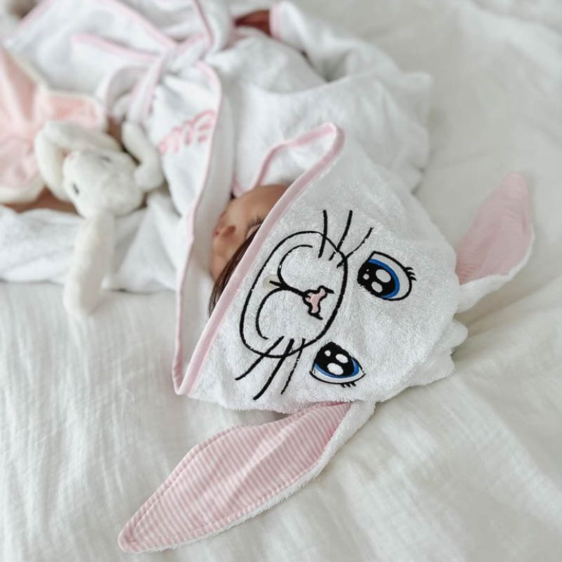 Baby wearing plush personalised bunny hooded robe.