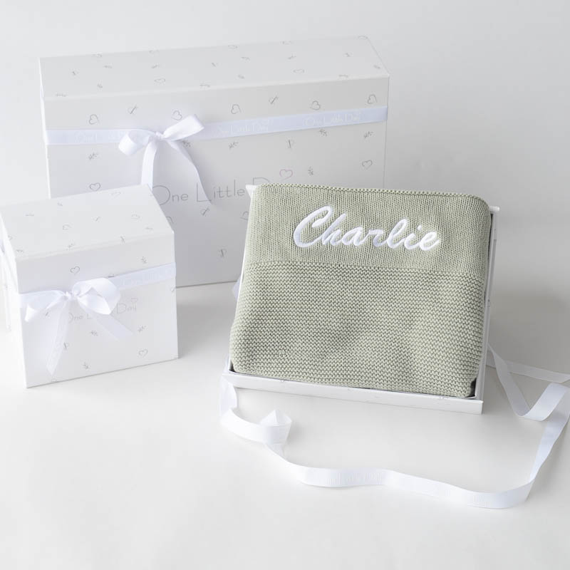 Sage personalised knitted baby blanket displayed in gift box.