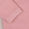 Blush Pink Knitted Cardigan Scallop Edge Close-up of blush pink knitted baby cardigan sleeve showing ribbed cuff and textured knit detail.