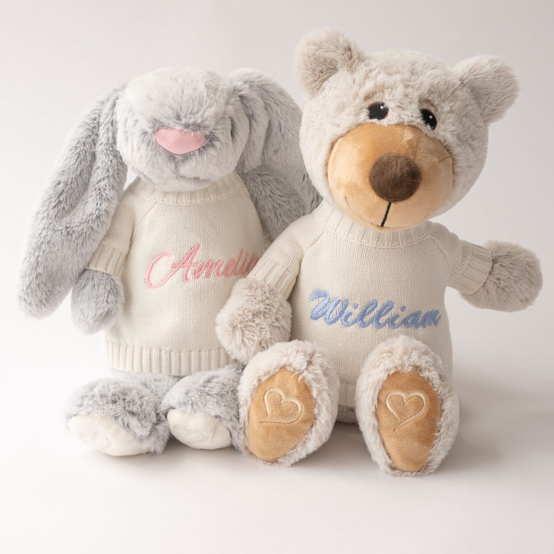 Personalised bunny and teddy bear plush toys wearing knit jumpers.