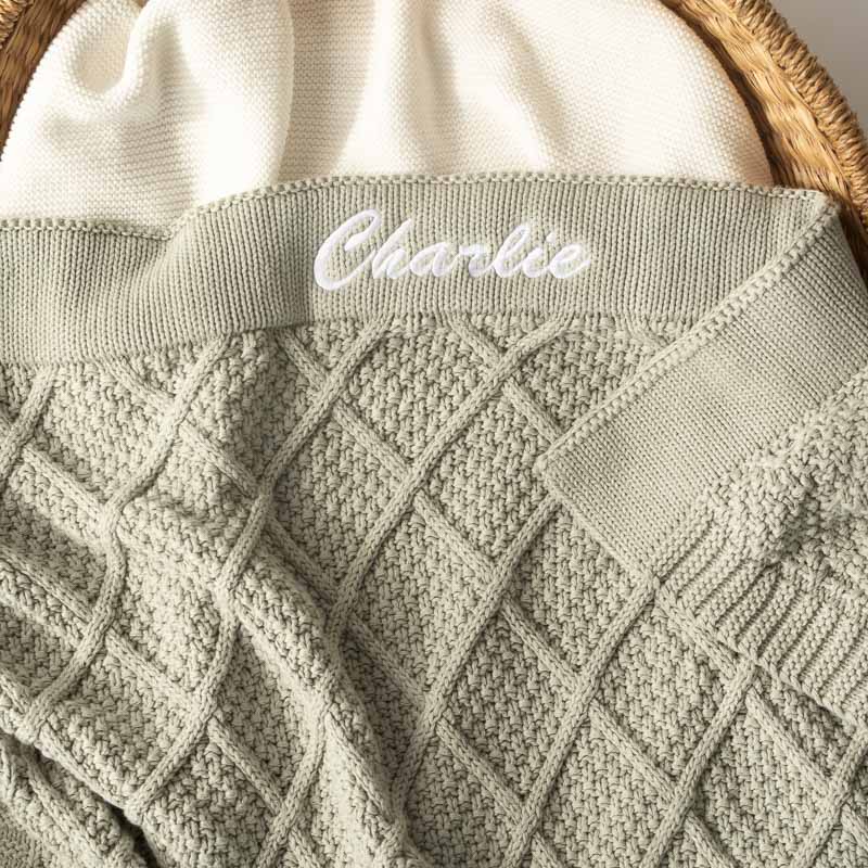 Personalised sage green diamond knitted baby blanket with name embroidery.