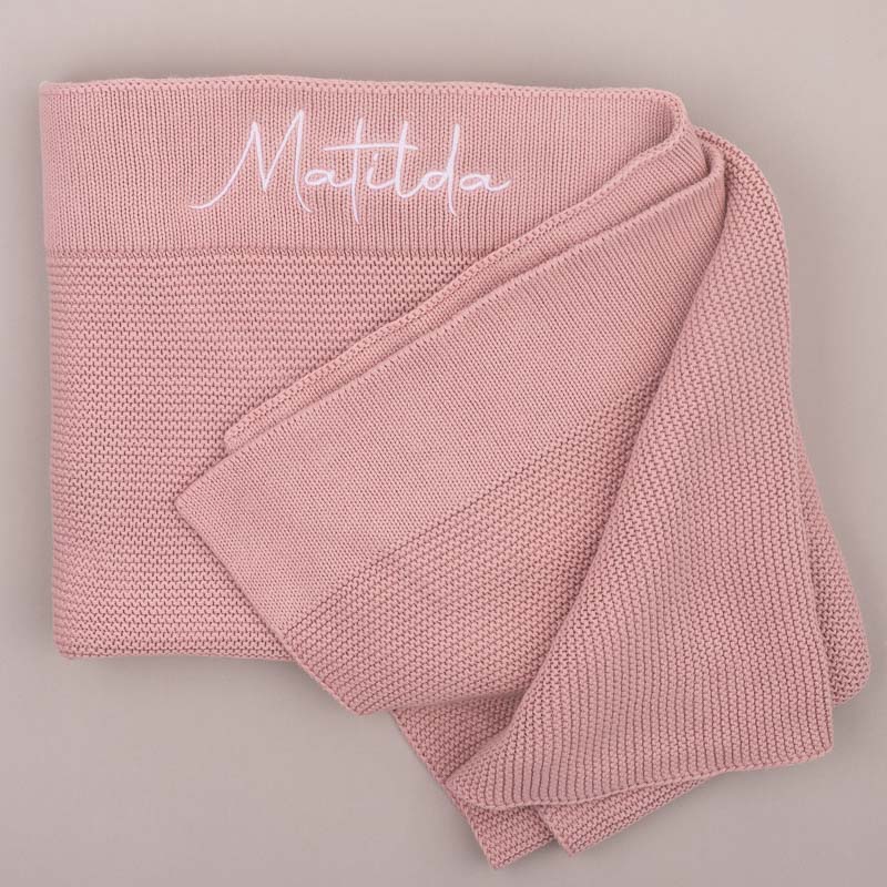 Blush pink knitted baby blanket embroidered with name.