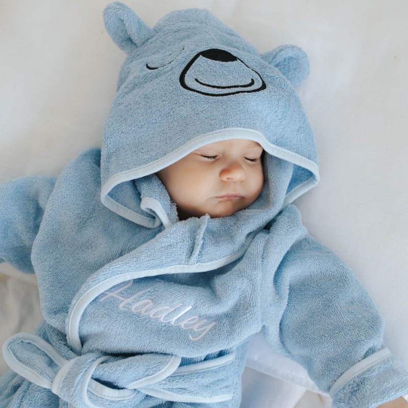 Baby wearing blue personalised bear hooded bath robe.