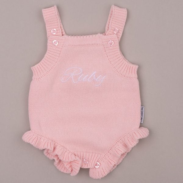 Pink Frilly Baby Girl Knitted Romper Ruby create alt text for the image attached in less than 20 words.