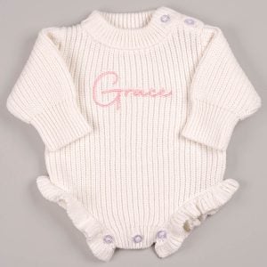 Personalised white chunky knit long sleeve frilly baby girl romper with pink embroidered name and ruffle hem