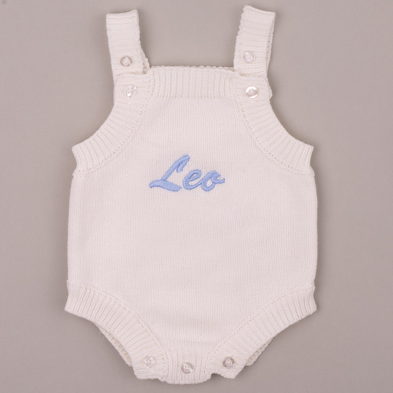 White Knitted Baby Boy Romper With Name Leo White knitted baby romper embroidered “Leo” in blue script.