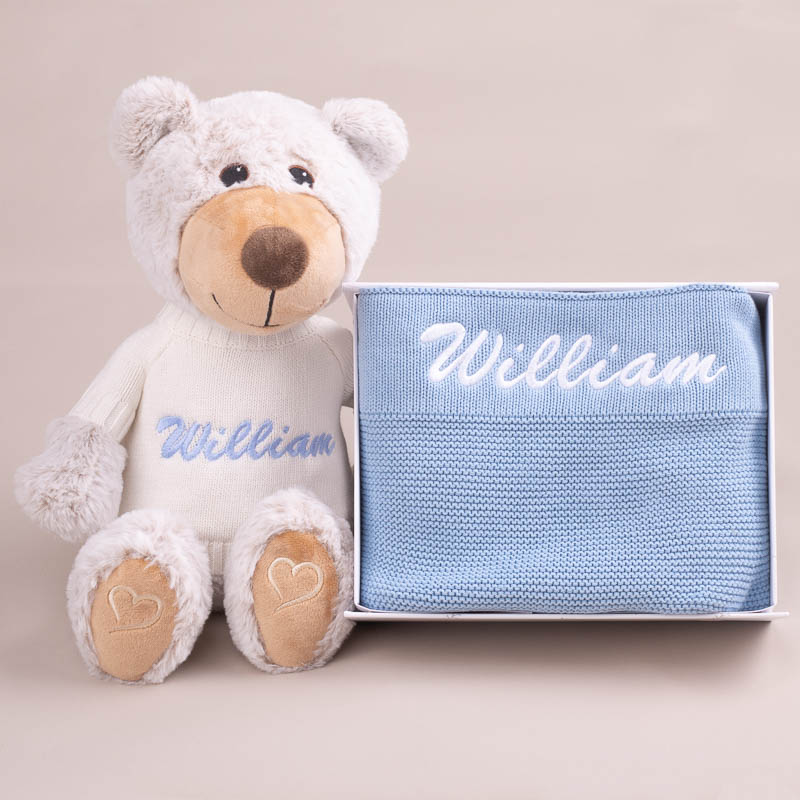 Personalised teddy bear and blue knitted baby blanket gift set.