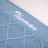Blue Diamond Baby Blanket Close Up Thomas Close-up of personalised blue diamond knit baby blanket with white name embroidery on ribbed border