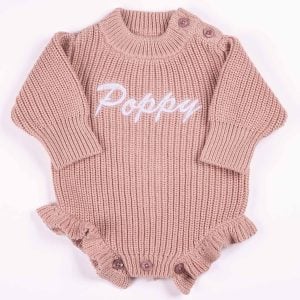 Personalised blush pink chunky knit long sleeve frilly baby girl romper with white embroidered name and ruffle hem