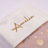 Light Pink & Gold Baby Christmas Stocking Close Up Close-up of personalised light pink and gold snowflake velvet baby Christmas stocking with gold Amelia embroidery on white cuff