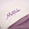 Close-up of personalised lilac velvet baby Christmas stocking with purple Matilda embroidery on white cuff