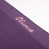 Purple Knitted Baby Blanket Close Up Close-up of personalised purple knit baby blanket with pink Olivia embroidery on ribbed border