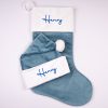 Sky Blue Christmas Stocking & Hat Baby Gift Set Henry Personalised sky blue velvet baby Christmas stocking and matching Santa hat with blue Henry embroidery on white cuffs.