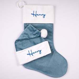Personalised sky blue velvet baby Christmas stocking and matching Santa hat with blue Henry embroidery on white cuffs.