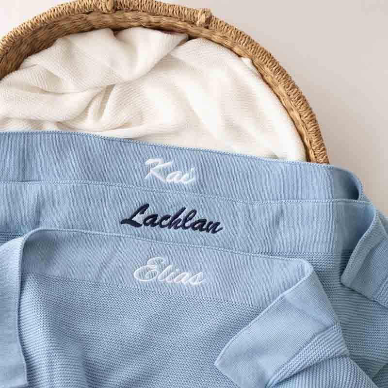 Three personalised Blue Knitted baby blankets showing various font comparisons.