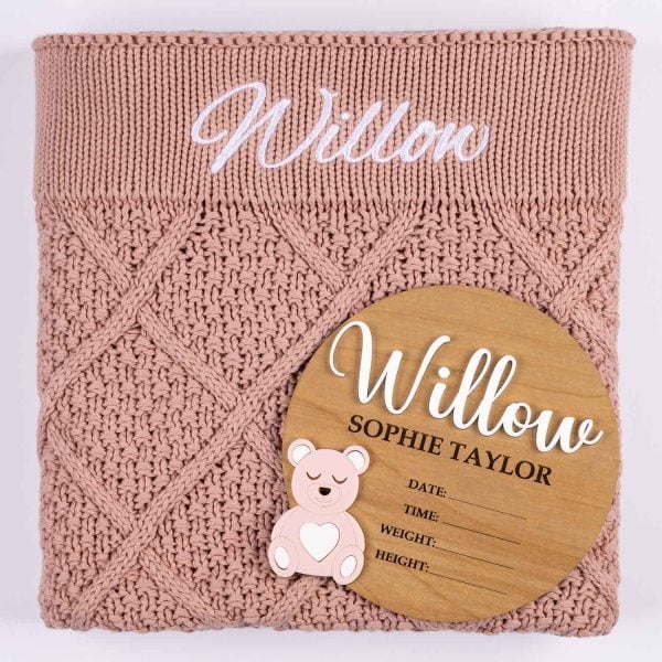 Blush Pink Diamond Knit And Bear Girl Birth Announcment Disc. Willow Blush pink diamond knitted personalised baby blanket with white embroidered script name displayed alongside a wooden bear birth announcement disc with pink acrylic bear and birth detail fields.