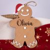 Gingerbread Man Personalised Christmas Keepsake Personalised wooden gingerbread man Christmas ornament with Olivia engraved and red Santa hat detail
