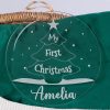Personalised clear acrylic Christmas bauble engraved with My First Christmas Amelia and tree design