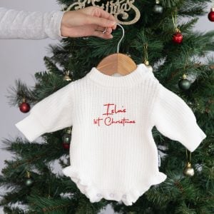 Personalised white knitted baby Christmas romper with frills and red embroidered First Christmas design.